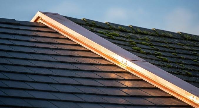 Close-up of roof tiles with a copper strip installed as a long-term moss protection solution.