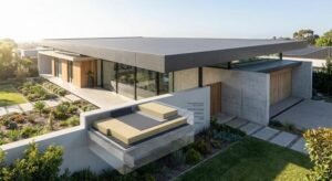 Modern house with a professionally renovated flat roof showing layers of insulation and waterproofing membrane.