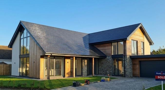 A modern house with a professional anthracite roof coating, showcasing a clean and durable renovated finish.
